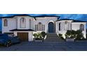 Stunning exterior view of a two-story home with a black roof, blue front door, and a 3-car garage at 1384 Harbor Dr, Sarasota, FL 34239
