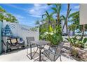 Outdoor patio area with table, chairs, and tropical plants for relaxing at 170 Roosevelt Dr # 2, Sarasota, FL 34236