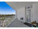 Exterior balcony view showcasing the condo entrance, blue sky and beautiful treetop views at 1770 Benjamin Franklin Dr # 407, Sarasota, FL 34236