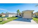 The front exterior shows the home, an attached garage, a well-maintained lawn and a shared drive at 2330 28Th E Ave, Palmetto, FL 34221