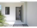 Modern home's open front door showcasing the clean, bright interior and wood flooring at 2335 Oak Ter, Sarasota, FL 34231