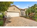 Attractive single-Gathering home with a two-car garage, tile roof, and manicured landscaping at 2745 62Nd E Ave, Ellenton, FL 34222