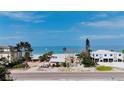 Charming beachfront neighborhood with homes nestled among palm trees and sandy shores at 2944 Gulf Of Mexico Dr, Longboat Key, FL 34228
