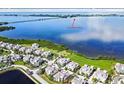 Stunning aerial view of the island community with views of the bay and a nearby bridge to Anna Maria Island at 311 Compass Point Dr # 101, Bradenton, FL 34209