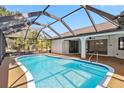 Inviting screened-in pool with clear blue water, offering a perfect oasis for relaxation and entertainment at 3239 Daytona Dr, Punta Gorda, FL 33983