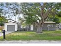 Charming single-story home with brick facade, mature shade tree, and attached garage at 3303 32Nd W St, Bradenton, FL 34205