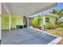 Wide angle shot of the home's covered carport and lush greenery at 3500 Green View Ct # 45, Sarasota, FL 34231