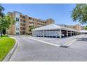Exterior view showing condo building and covered parking at 3750 Pinebrook Cir # 405, Bradenton, FL 34209