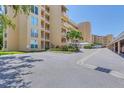 Exterior of the condo building shows visitor parking and lush landscaping at 3750 Pinebrook Cir # 405, Bradenton, FL 34209