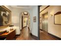 Classic condo hallway featuring hardwood floors, arched doorways, and elegant elevator access at 420 Golden Gate Pt # 200A, Sarasota, FL 34236