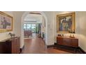 Inviting condo foyer boasts wood floors, art niches, and an archway leading to the living area with water views at 420 Golden Gate Pt # 200A, Sarasota, FL 34236