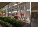 Exterior view of condo building with vibrant tropical landscaping at 4420 Exeter Dr # L104, Longboat Key, FL 34228
