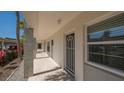 Exterior hallway with well-kept walkway and beautiful garden view at 4420 Exeter Dr # L104, Longboat Key, FL 34228
