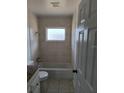 Bright bathroom features a tiled shower/bath combo, granite vanity, and neutral finishes at 4444 Swift Rd # 14, Sarasota, FL 34231