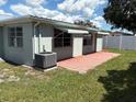 A cozy backyard patio with an air conditioning unit at 4833 Dogwood St, New Port Richey, FL 34653