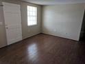 Clean bedroom with wood laminate flooring, natural light, and neutral color palette at 4833 Dogwood St, New Port Richey, FL 34653