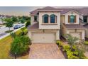 Charming two-story townhome with a brick driveway and desert landscaping at 5007 Sunnyside Ln, Bradenton, FL 34211