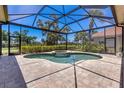 Screened-in pool area with a spa, providing a serene and private outdoor space at 52 Grande Fairway, Englewood, FL 34223