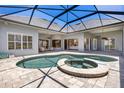 Inviting screened-in pool and patio area, perfect for relaxation and entertaining at 52 Grande Fairway, Englewood, FL 34223