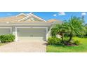 Attached two-car garage with a neutral color door and beautiful landscaping that enhances curb appeal at 5450 Fairfield Blvd, Bradenton, FL 34203