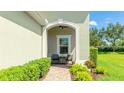 Charming covered front porch with seating area and beautiful landscaping at 5450 Fairfield Blvd, Bradenton, FL 34203