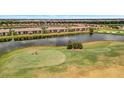 Aerial shot of a golf course community featuring a lake, fairways, and residential homes at 5624 Palmer Cir # 101, Bradenton, FL 34211