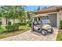 Close-up of a home with a golf cart parked on the brick paver driveway at 5624 Palmer Cir # 101, Bradenton, FL 34211