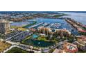 Beautiful aerial shot of a condo community with a marina, pond, tennis court, and lush landscaping at 606 Riviera Dunes Way # 306, Palmetto, FL 34221