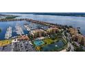 Scenic aerial view of condo complex by the water featuring a marina and well-maintained grounds at 606 Riviera Dunes Way # 306, Palmetto, FL 34221