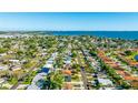 Wide aerial shot showcasing the home's location with beautiful water views nearby and lush landscaping throughout the neighborhood at 6423 Georgia Ave, Bradenton, FL 34207