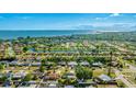 Aerial view showcasing the home's location with beautiful water views nearby and lush landscaping throughout the neighborhood at 6423 Georgia Ave, Bradenton, FL 34207