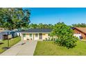 A well-maintained single-story home featuring a well-maintained lawn, tidy landscaping, and new roof at 6423 Georgia Ave, Bradenton, FL 34207