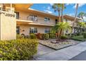 Charming condo exterior with lush landscaping, private balconies, and a clean, modern design at 6999 W Country Club N Dr # 224, Sarasota, FL 34243
