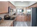 Modern kitchen featuring stainless steel appliances and granite countertops at 7005 River Hammock Dr # 204, Bradenton, FL 34212