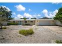 Charming single-story home with a well-manicured front yard, a metal roof, and a two-car garage at 7202 18Th Nw Ave, Bradenton, FL 34209