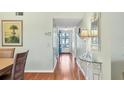 Bright hallway with wood flooring and a view to the front door at 7301 29Th Avenue W Dr # 108, Bradenton, FL 34209