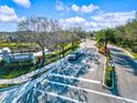 Community entrance showcasing lush landscaping and a tranquil pond at 7844 52Nd E Ter, Bradenton, FL 34203