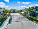 Gated community entrance featuring stately stone pillars and lush landscaping at 7844 52Nd E Ter, Bradenton, FL 34203