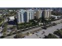 Scenic aerial view of modern condominiums with lush landscaping and parking at 800 N Tamiami Trl # 604, Sarasota, FL 34236