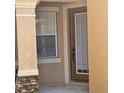 Home entryway showcasing a window, a front door, and a stone pillar detail at 8110 Villa Grande Ct, Sarasota, FL 34243