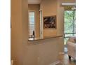 Kitchen area featuring a breakfast bar with sink, tile flooring, and natural lighting at 8110 Villa Grande Ct, Sarasota, FL 34243