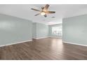 Spacious living room features modern ceiling fan and beautiful wood-look vinyl flooring at 913 64Th W St, Bradenton, FL 34209