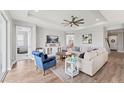 Bright and airy living room featuring a ceiling fan and hardwood floors at 1017 Fernleaf Run, Bradenton, FL 34212