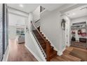 Elegant staircase with wood treads and iron railings, leading to the upper level at 1017 Fernleaf Run, Bradenton, FL 34212