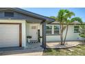 Cozy front porch adorned with potted plants and a 'hello there' door sign at 1227 Porpoise Rd, Venice, FL 34293