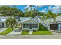 A quaint stone cottage with lush lawns and ample parking, radiating charm at 13 Oak St, Bradenton, FL 34208
