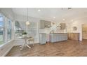 Bright kitchen with wood floors, custom cabinets, and a charming breakfast nook for relaxed dining at 13 Oak St, Bradenton, FL 34208