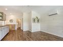 Open-concept space boasts hardwood floors, shiplap walls, and natural light, ideal for relaxing or entertaining at 13 Oak St, Bradenton, FL 34208