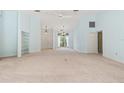 Large living room with built-in shelving, fan and light blue painted walls at 13511 4Th Plz E, Bradenton, FL 34212