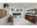 A beautifully decorated bedroom with dinosaur wall art, a dresser, and coordinated furnishings at 13634 Tropical Breeze Way, Hudson, FL 34669